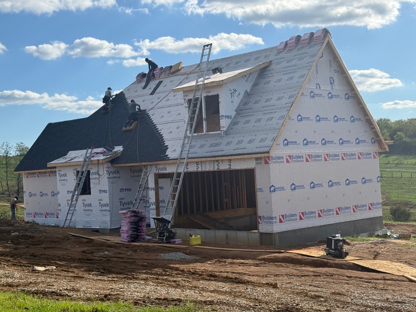 New home under construction with roofing crew
