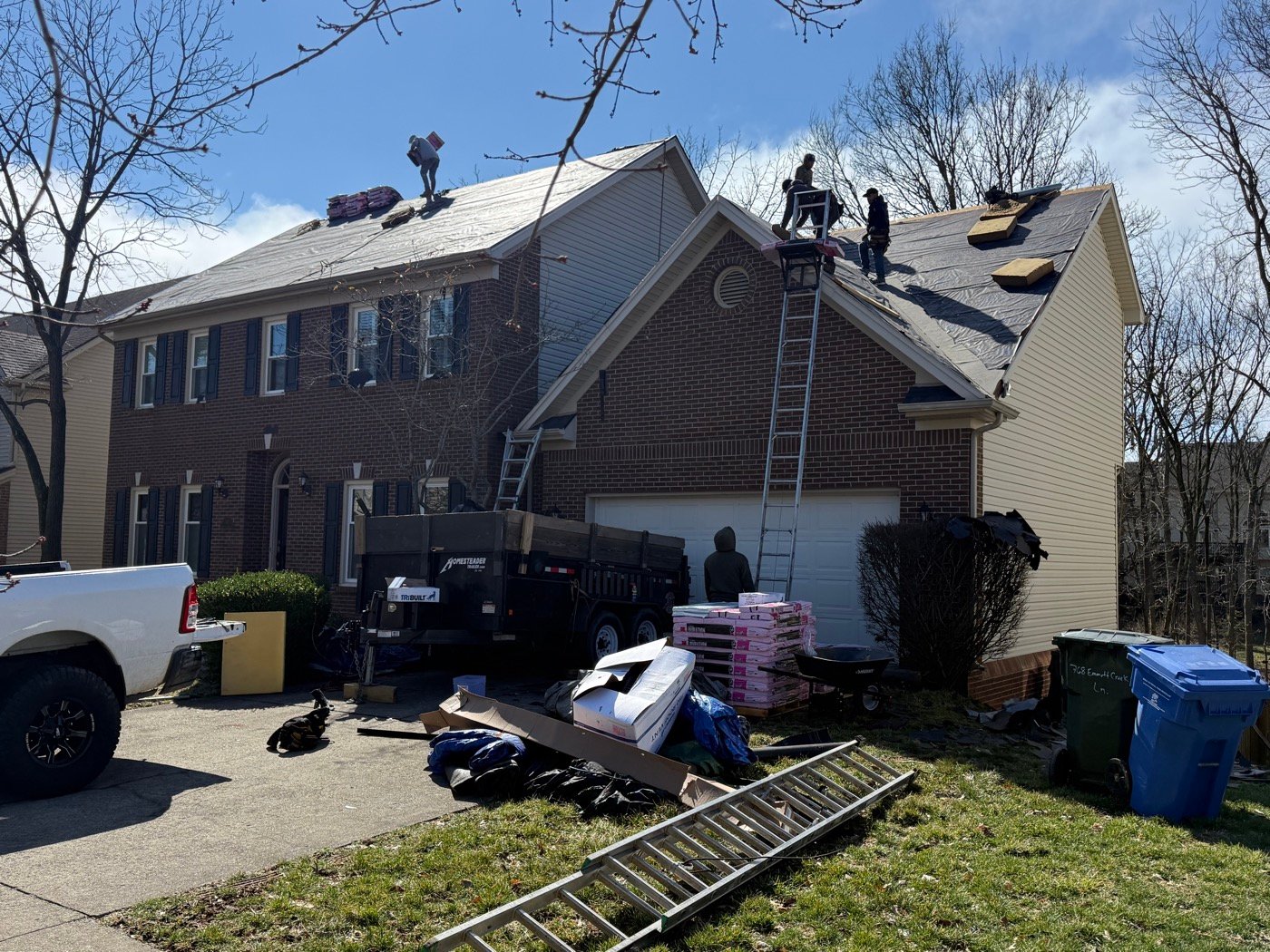 Two-story brick home during full roof replacement