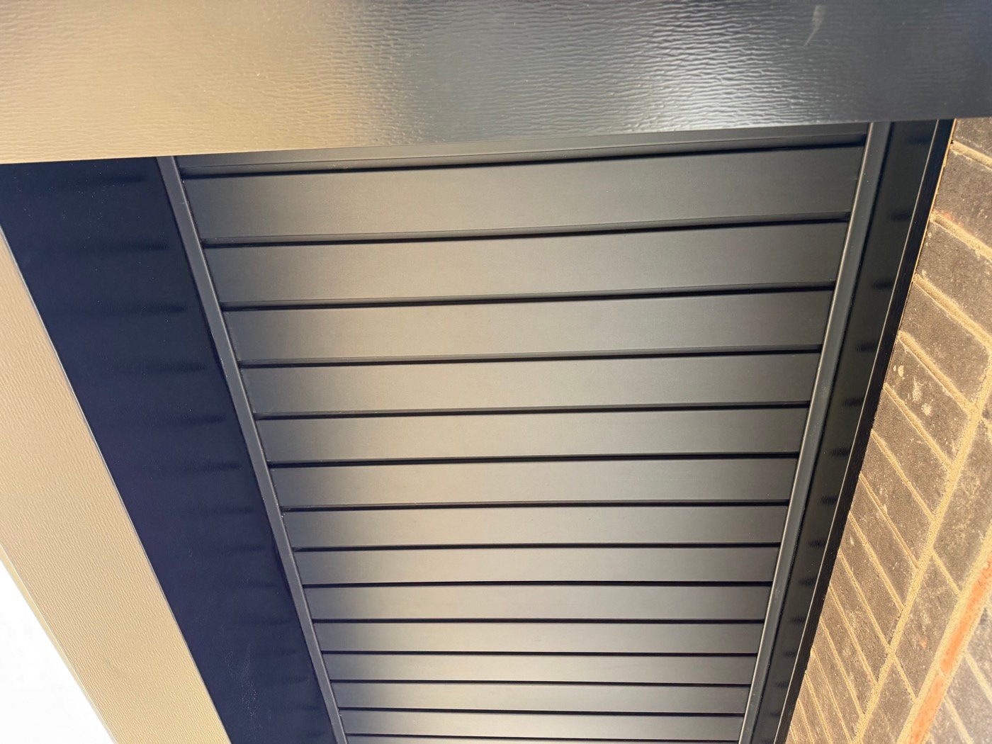 Finished dark metal porch ceiling detail